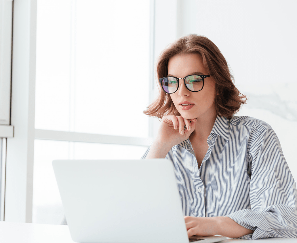 charming-businesswoman-glasses-striped-shirt-working-with-laptop-computer-while-siting-home-min